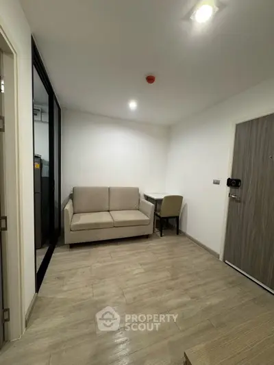 Modern compact living room with beige sofa and small dining area