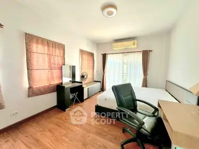 Spacious bedroom with modern furnishings and natural light