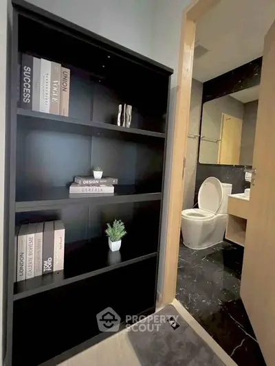 Modern bathroom with sleek black shelving and elegant decor
