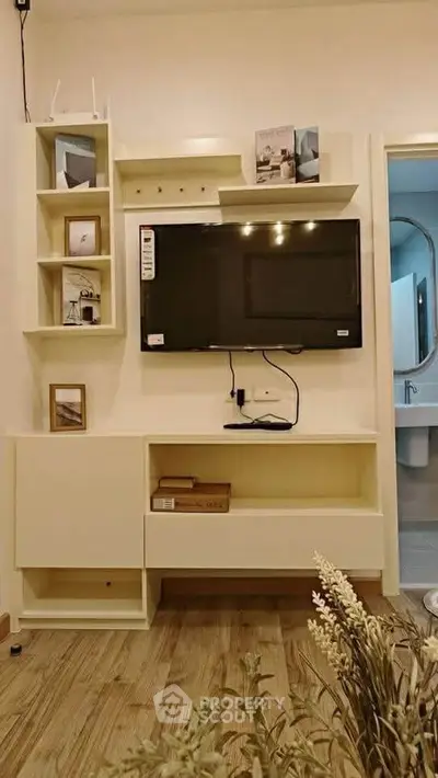 Modern living room with wall-mounted TV and stylish shelving unit