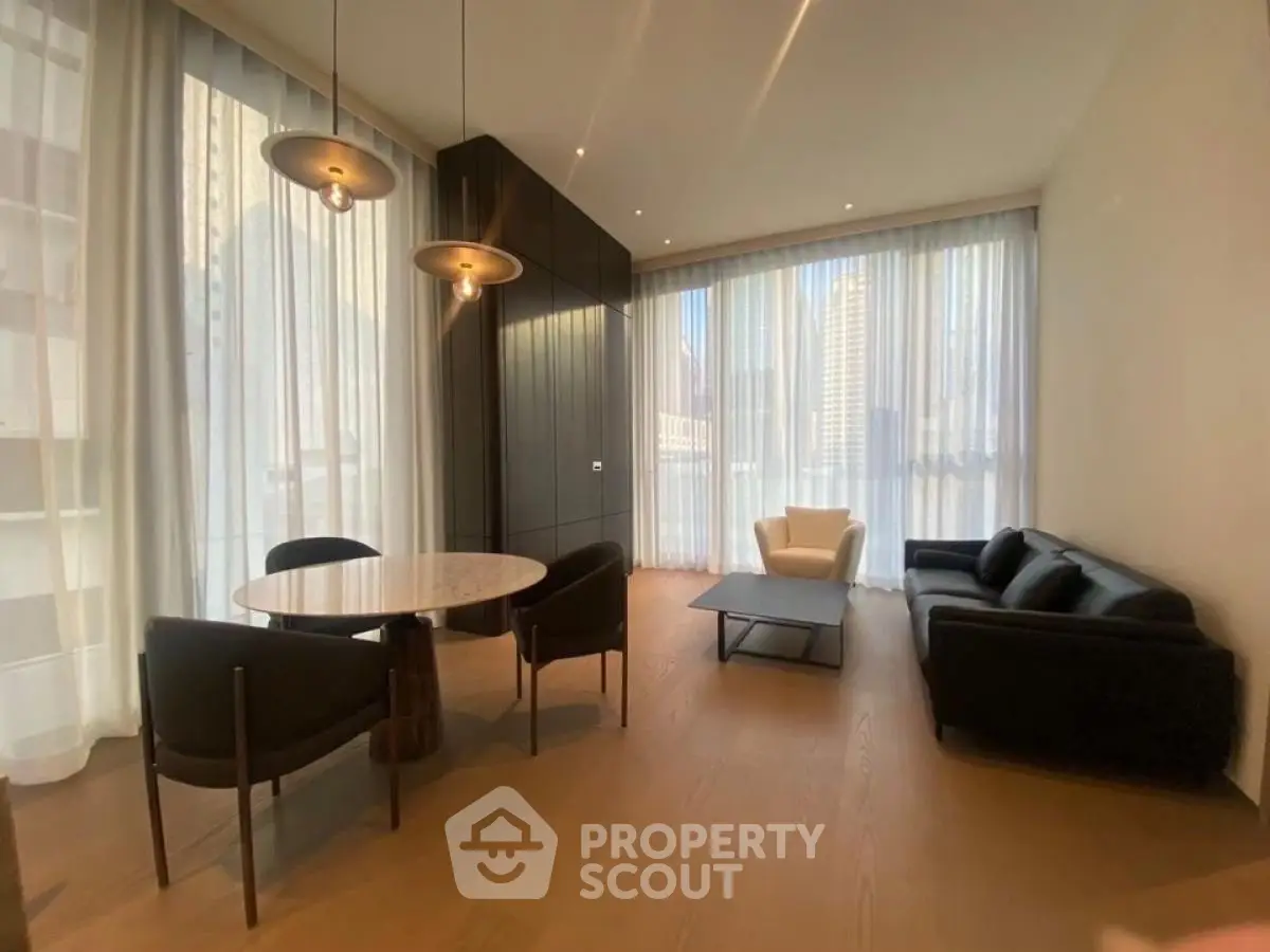 Luxurious modern living room with elegant furniture and floor-to-ceiling windows in a high-rise apartment.