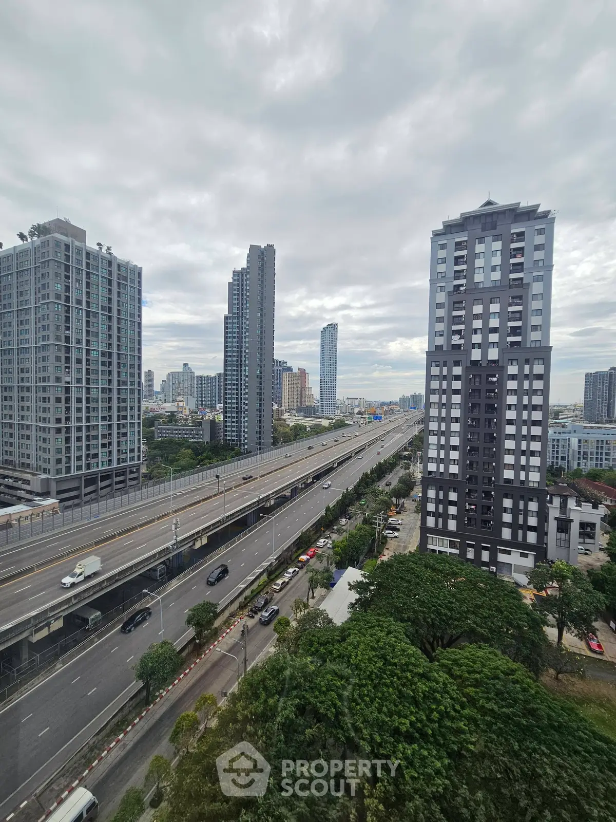 Stunning cityscape view with modern high-rise buildings and highway access, ideal for urban living.