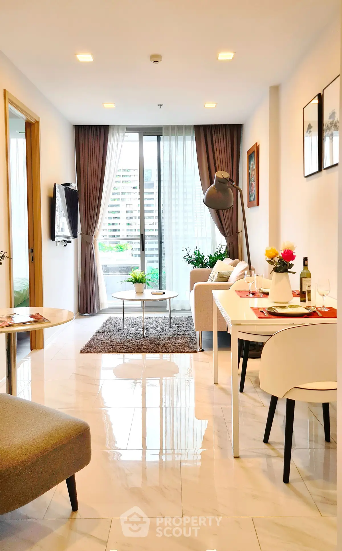Modern living room with elegant decor and natural light in a high-rise apartment.