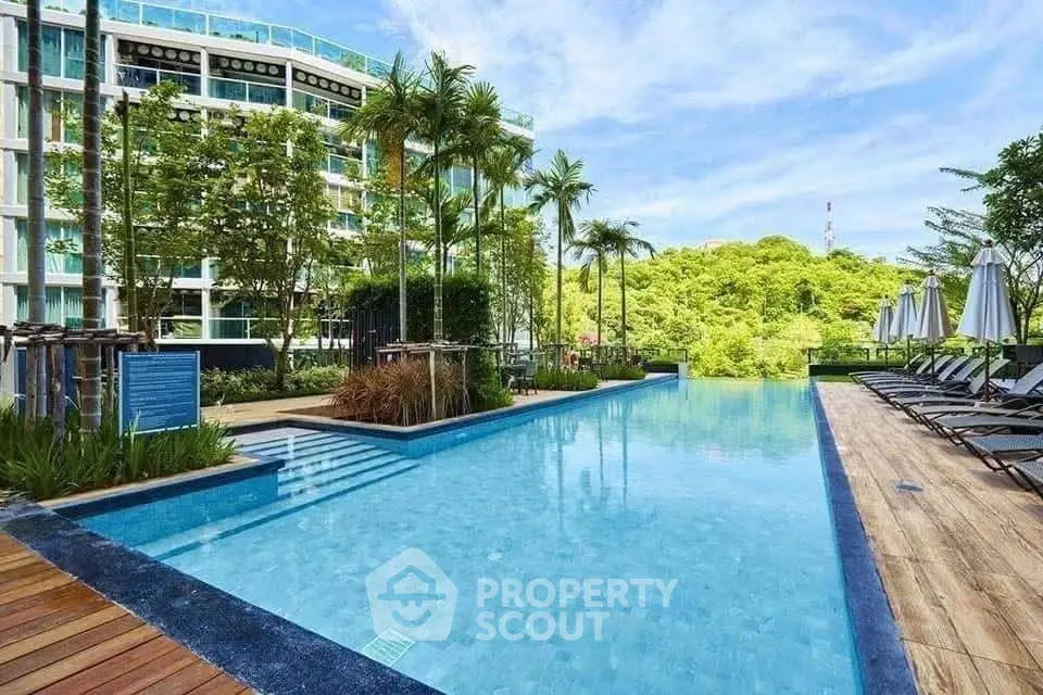 Luxurious condominium with stunning pool and lush greenery view.