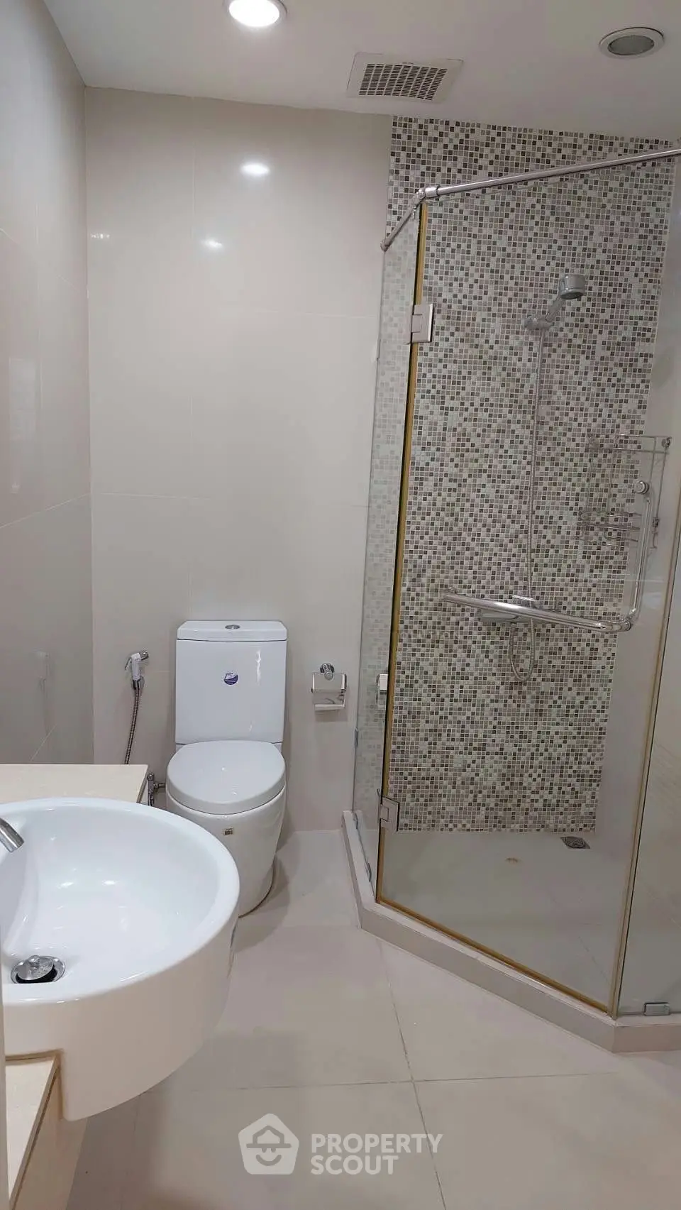 Modern bathroom with glass shower and sleek fixtures in a contemporary apartment.