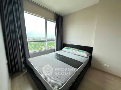 Modern bedroom with large window offering stunning city view, featuring sleek design and ample natural light.