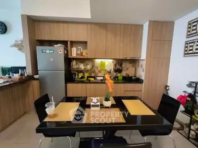 Modern kitchen with sleek cabinetry and dining area, perfect for culinary enthusiasts.