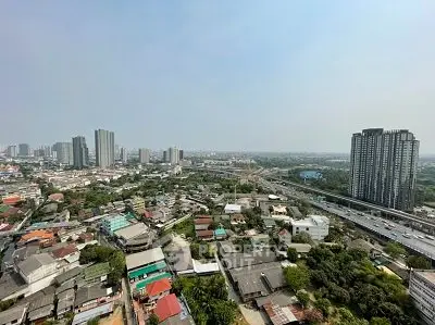 Stunning cityscape view from high-rise building showcasing urban skyline and residential areas.