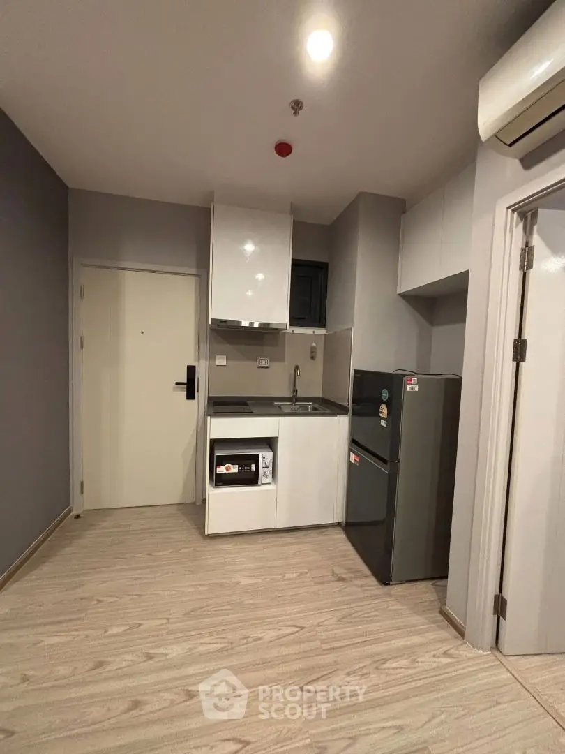 Modern compact kitchen with sleek appliances and stylish design