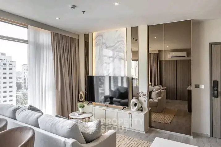 Luxurious modern living room with large windows and elegant decor in a high-rise apartment.