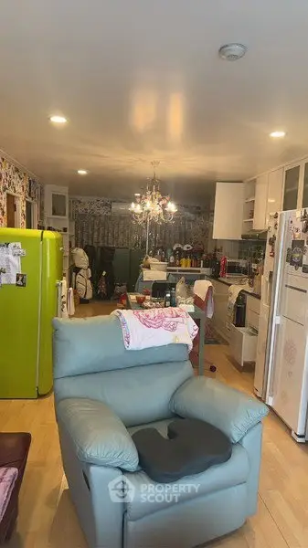Cozy open-layout kitchen and living area with colorful decor and modern appliances.