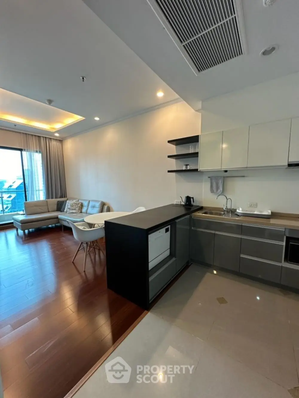 Modern open-layout kitchen and living room with sleek design and natural light.