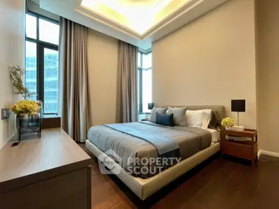 Luxurious modern bedroom with elegant decor and large windows offering natural light.