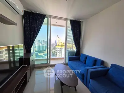 Modern living room with blue sofa and city view balcony