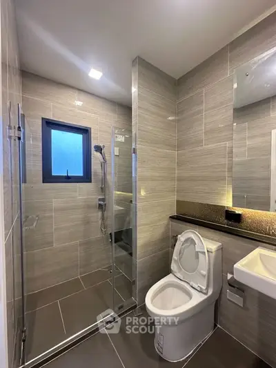 Modern bathroom with glass shower and sleek fixtures