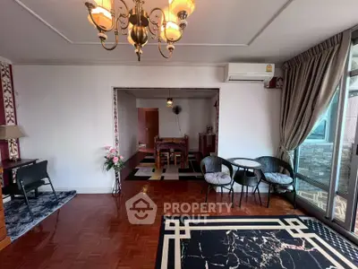 Spacious living room with elegant decor and large windows offering natural light.