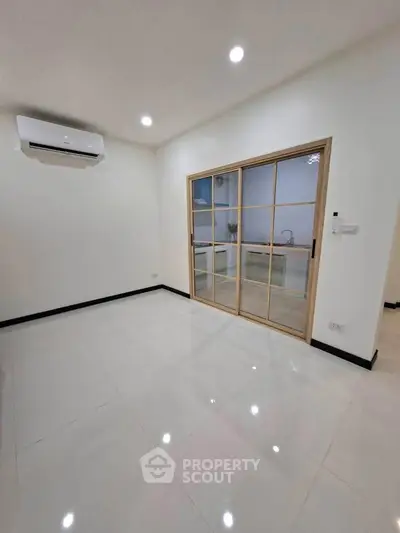 Modern living room with sliding glass doors and air conditioning unit