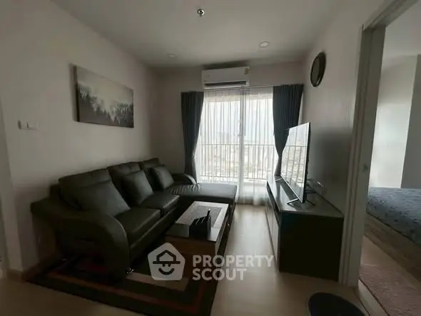 Modern living room with sleek furniture and natural light, perfect for relaxation and entertainment.