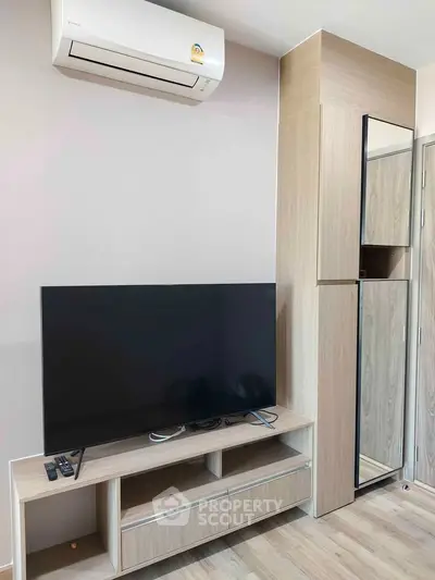 Modern living room with sleek TV setup and air conditioning