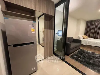 Modern apartment interior with sleek kitchen and cozy bedroom view.