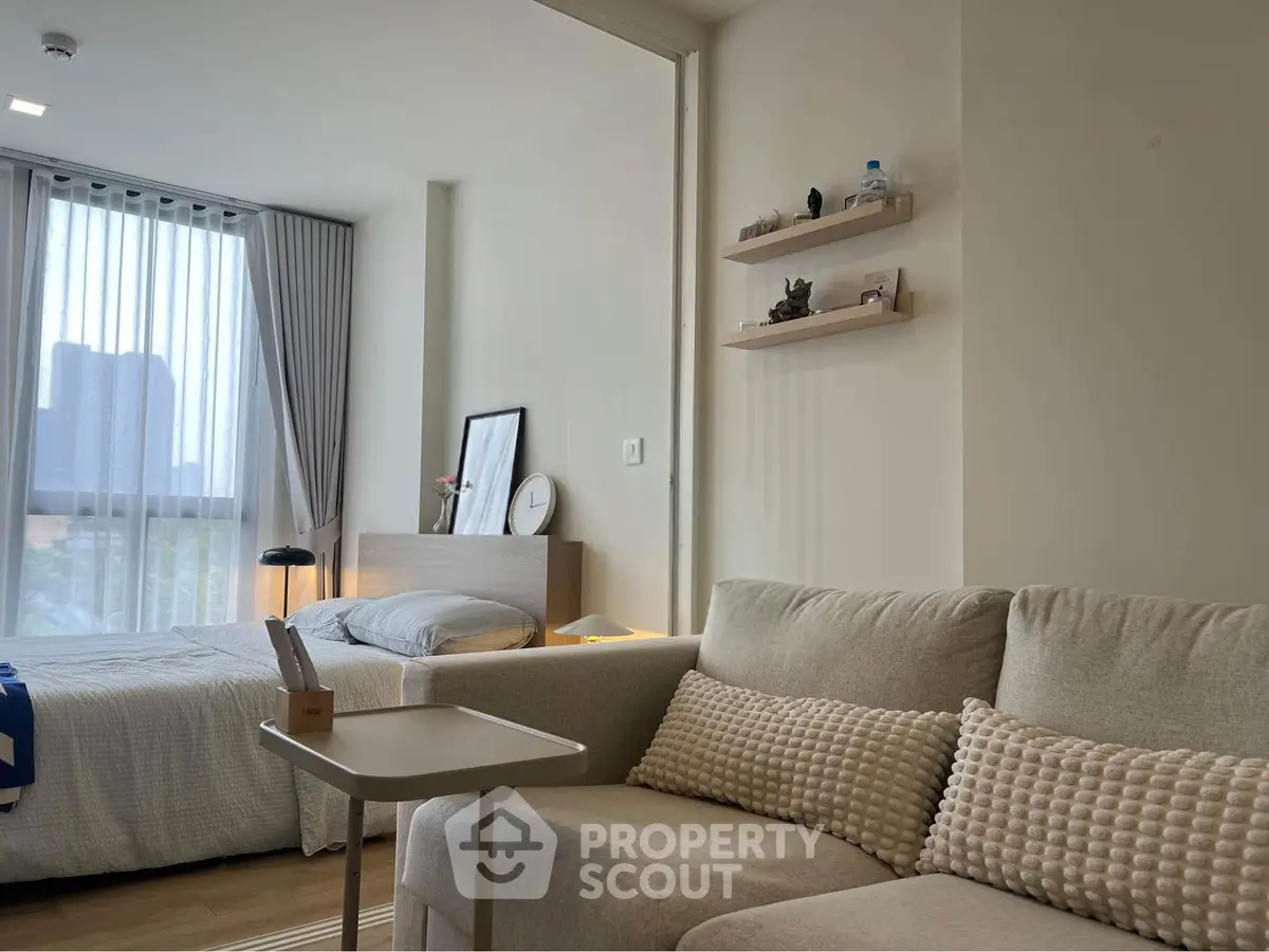 Modern studio apartment with cozy living area and natural light