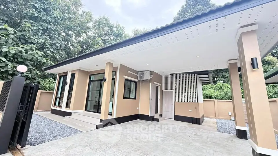 Modern single-story home with sleek design and spacious driveway, surrounded by lush greenery.