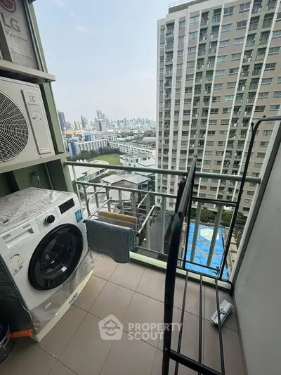 High-rise apartment balcony with city view and laundry area