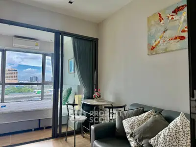 Modern living room with glass partition and city view, featuring cozy seating and stylish decor.