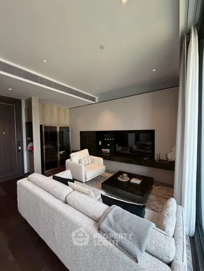 Luxurious modern living room with plush seating and sleek entertainment center