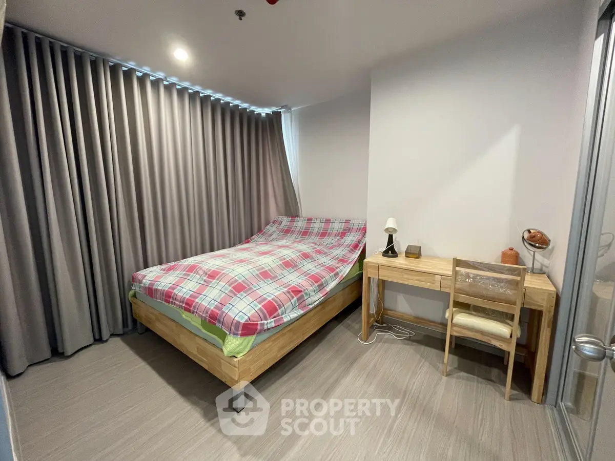 Cozy bedroom with modern wooden furniture and stylish curtains