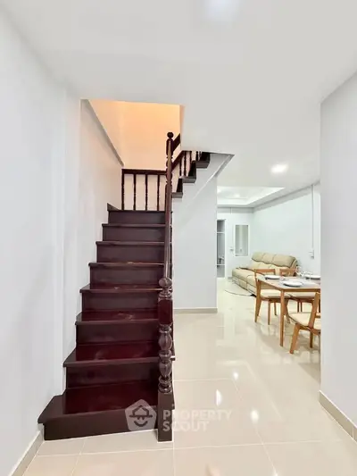 Modern interior with elegant staircase and cozy living area, perfect for stylish urban living.