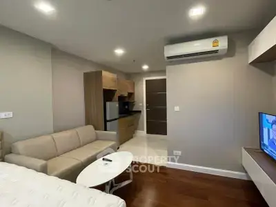 Modern studio apartment with cozy living area and compact kitchen