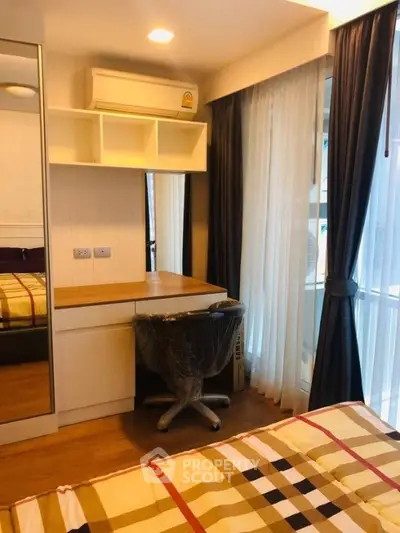 Cozy bedroom with study desk and large window in modern apartment