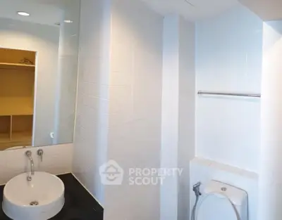 Modern bathroom with sleek white tiles and stylish fixtures