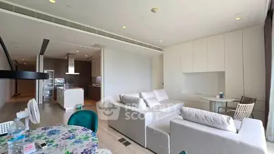 Spacious modern living room with open kitchen and elegant furnishings