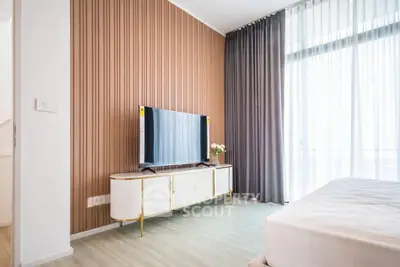 Modern bedroom with stylish TV stand and floor-to-ceiling windows