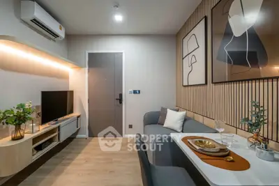 Modern living room with stylish decor, wall art, and cozy seating area.