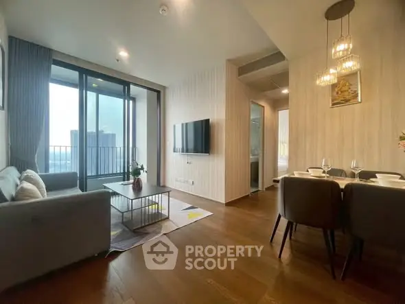 Modern living room with elegant dining area and city view balcony