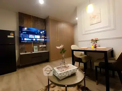 Modern living room with stylish decor and dining area in a cozy apartment.