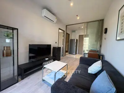 Modern living room with sleek furniture and air conditioning in a stylish apartment.