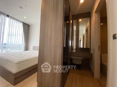 Modern bedroom with large windows and elegant wooden furniture, featuring a cozy ambiance and ample natural light.