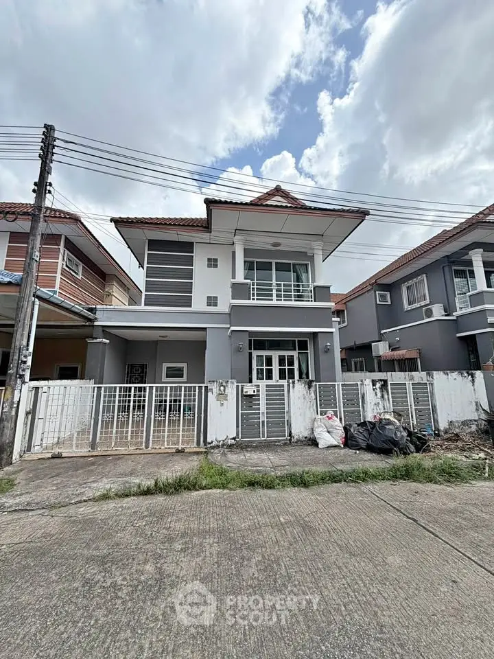 Charming two-story house with modern design and spacious balcony in a serene neighborhood.