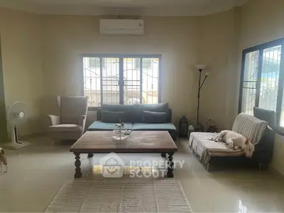 Spacious living room with modern furniture and large windows for natural light.