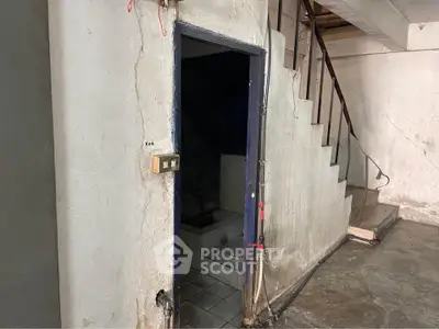 Spacious basement with staircase, ideal for renovation or storage space.