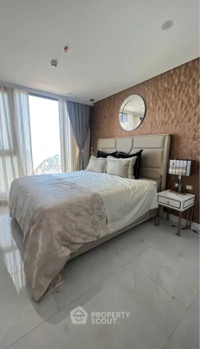 Luxurious bedroom with modern decor and large windows offering city views