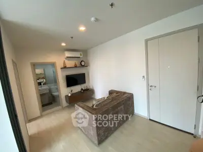 Modern living room with cozy sofa and wall-mounted TV in a stylish apartment.