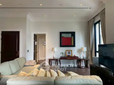 Elegant living room with modern decor, large windows, and stylish furniture.