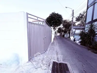 Secure gated entrance to residential property on a quiet street, ideal for privacy and safety.