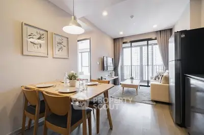 Modern open-plan living room with dining area and balcony view