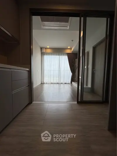 Spacious modern interior with sliding glass doors and elegant flooring, perfect for stylish living.